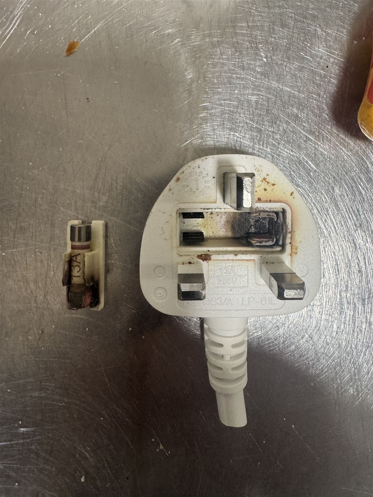 Burnt plug and blown fuse found during an electrical fault finding call-out